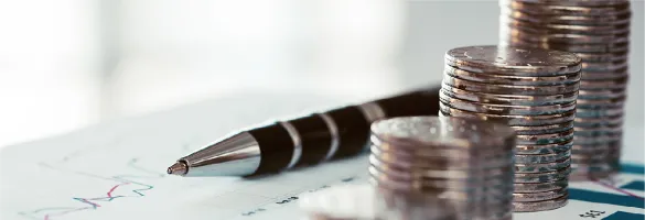 a pen and a stack of coins
