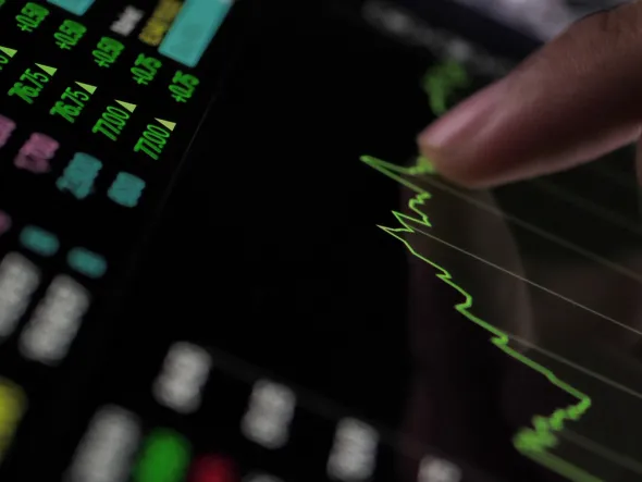 a finger pointing at a graph on a screen a finger pointing at a graph on a screen