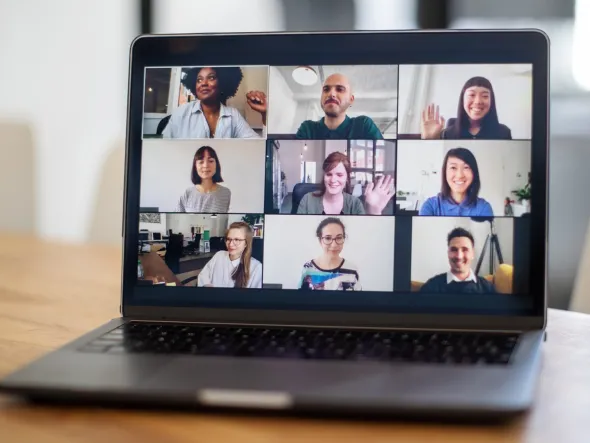 a laptop with a group of people on the screen a laptop with a group of people on the screen