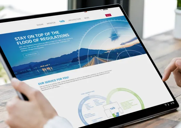 a hand holding a phone and looking at a website on a tablet