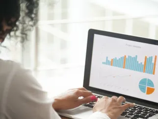 a woman typing on a laptop