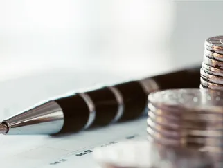 a pen and a stack of coins