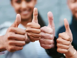 a group of people giving thumbs up
