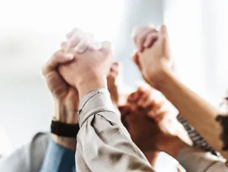 a group of people holding hands