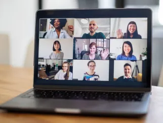 a laptop with a group of people on the screen