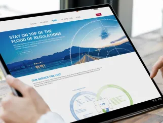 a hand holding a phone and looking at a website on a tablet