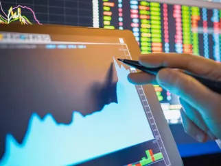 a hand pointing at a graph on a screen