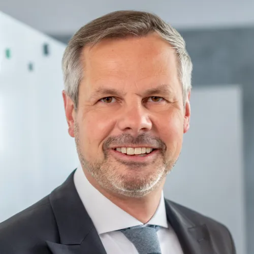 a man in a suit smiling