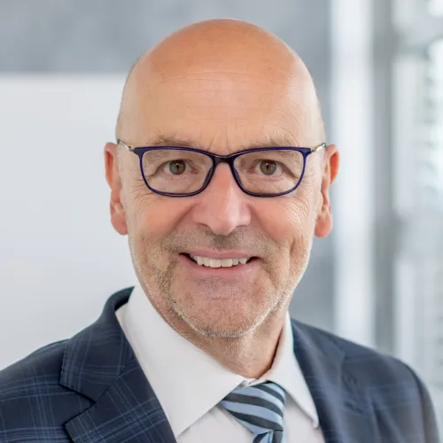 a man wearing glasses and a suit